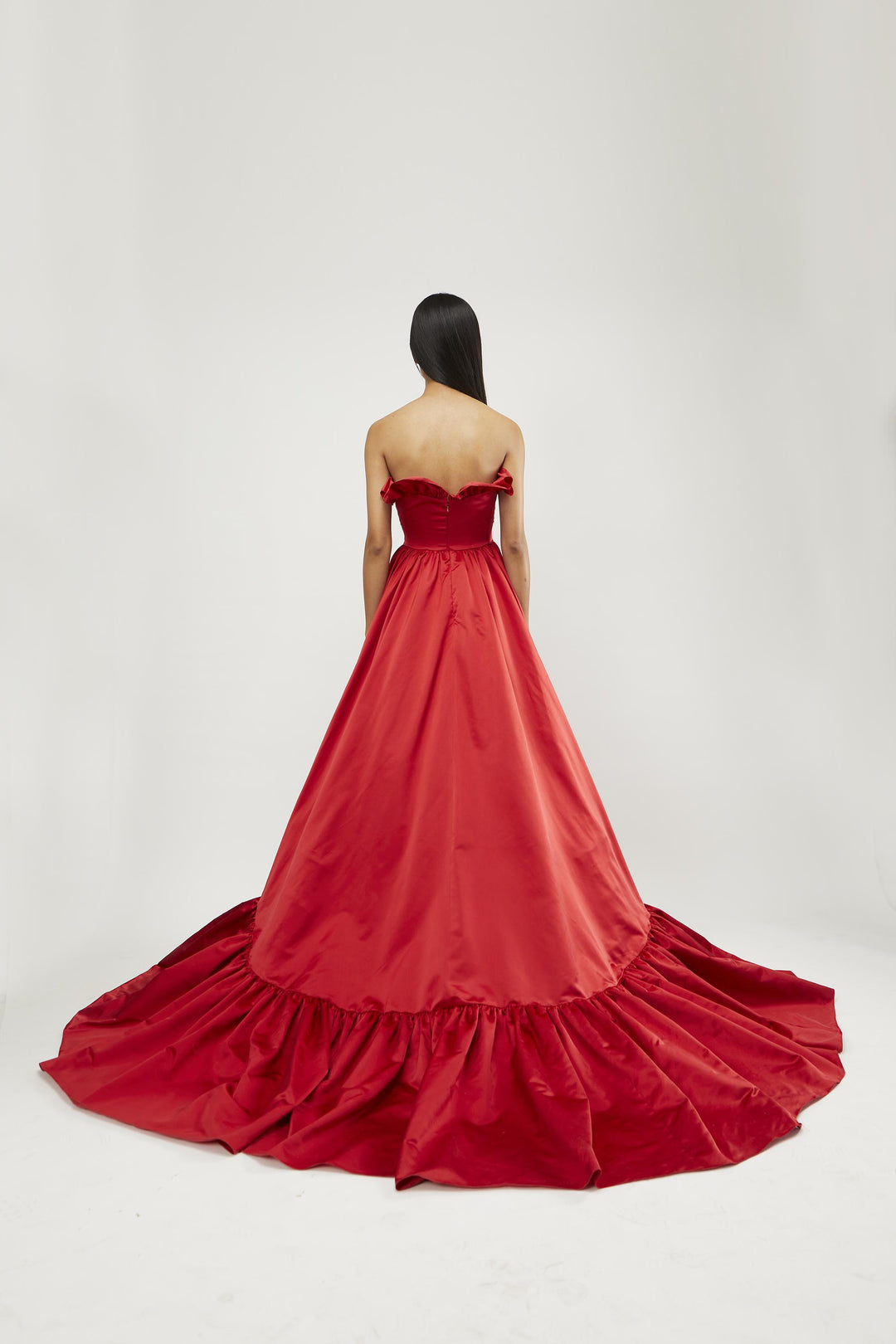 Strapless high-low gown with overlapping ruffled body and hem