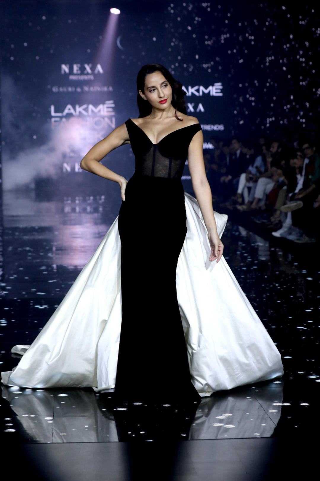 Off shoulder velvet gown with  corsetted body and contrast trailing bustle