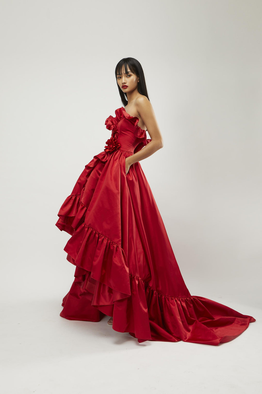 Strapless high-low gown with overlapping ruffled body and hem