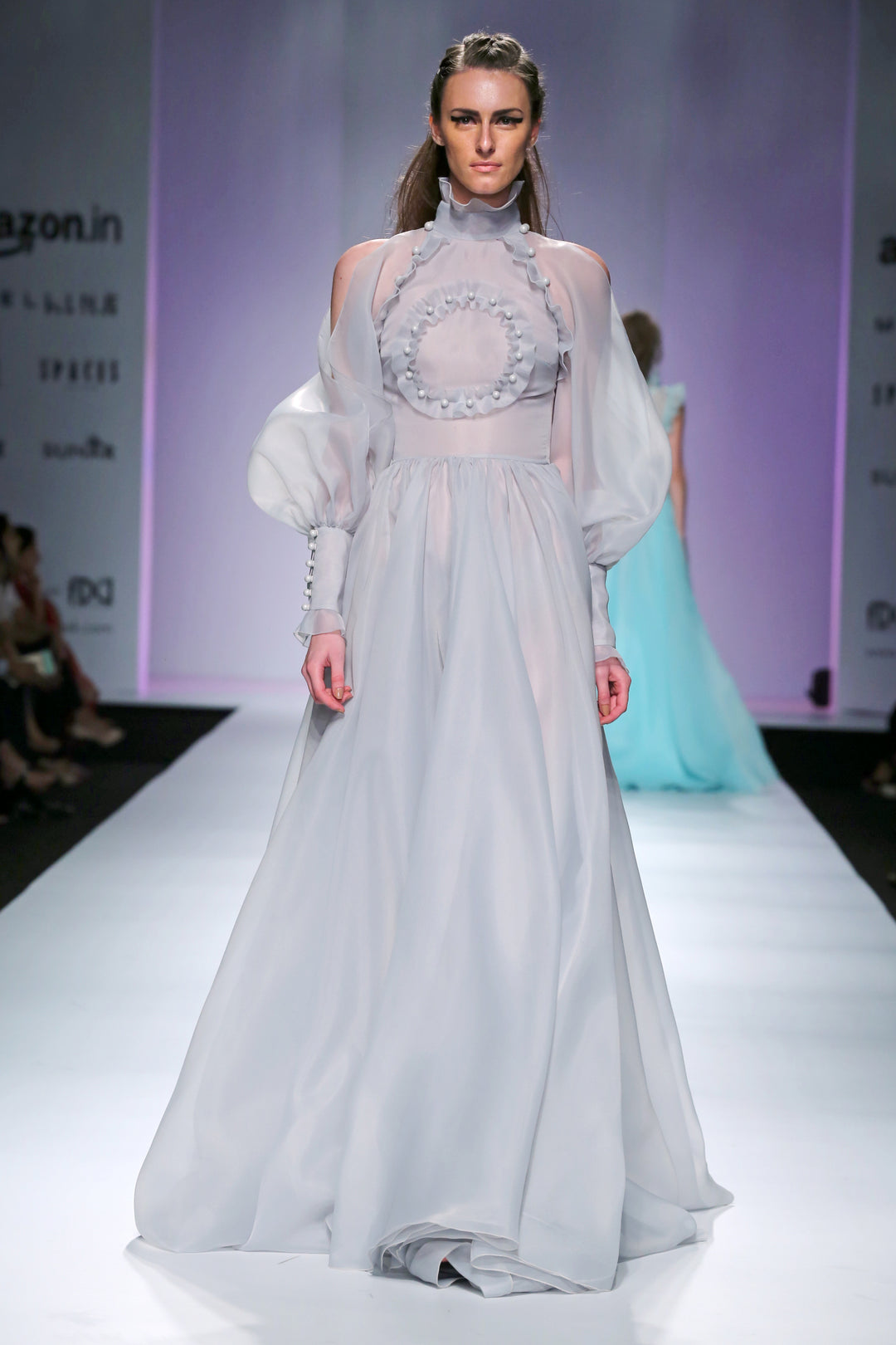 High collared gown with long pouf sleeves and frill texturing