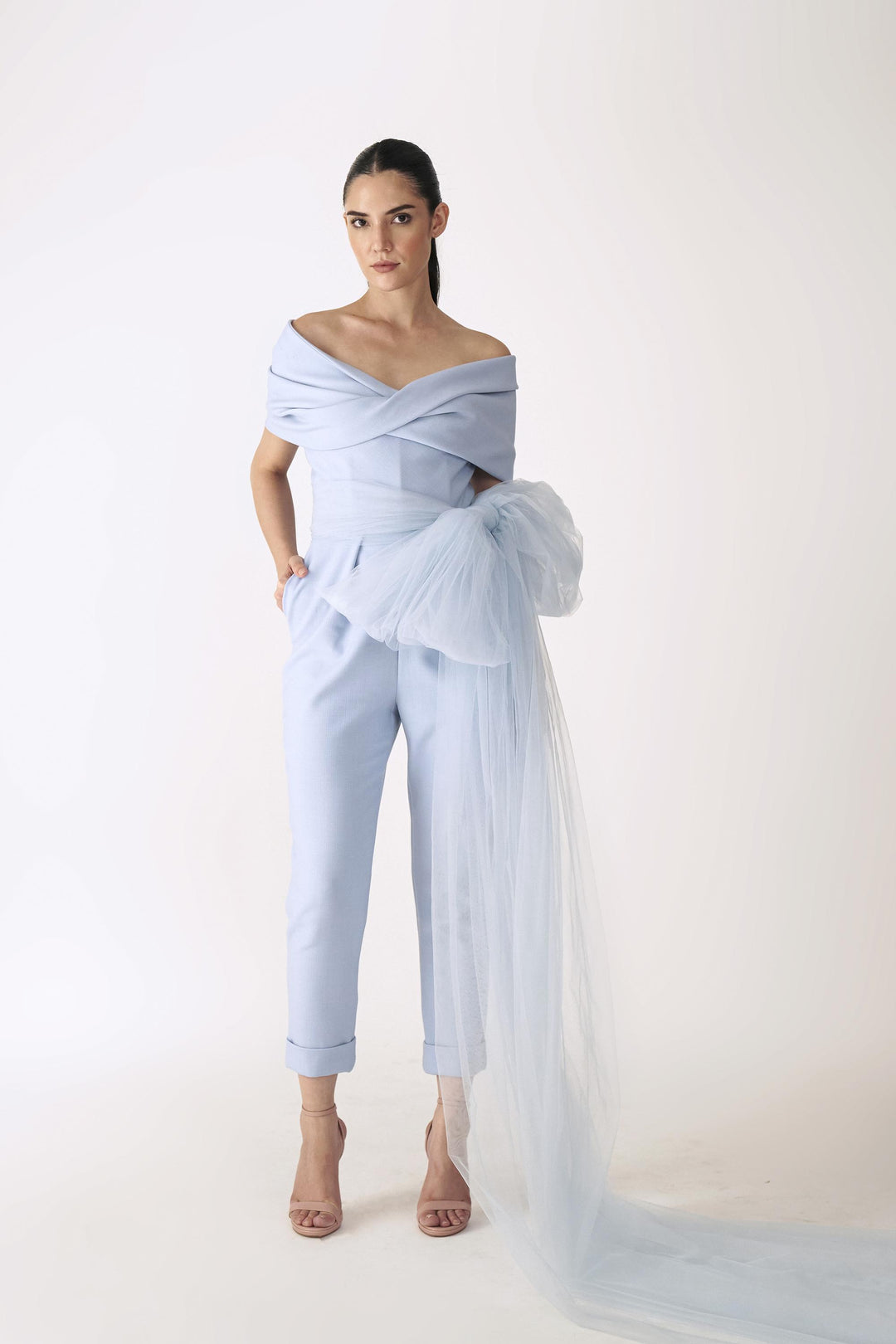 Internally corseted jumpsuit with twisted drape and tapered pants