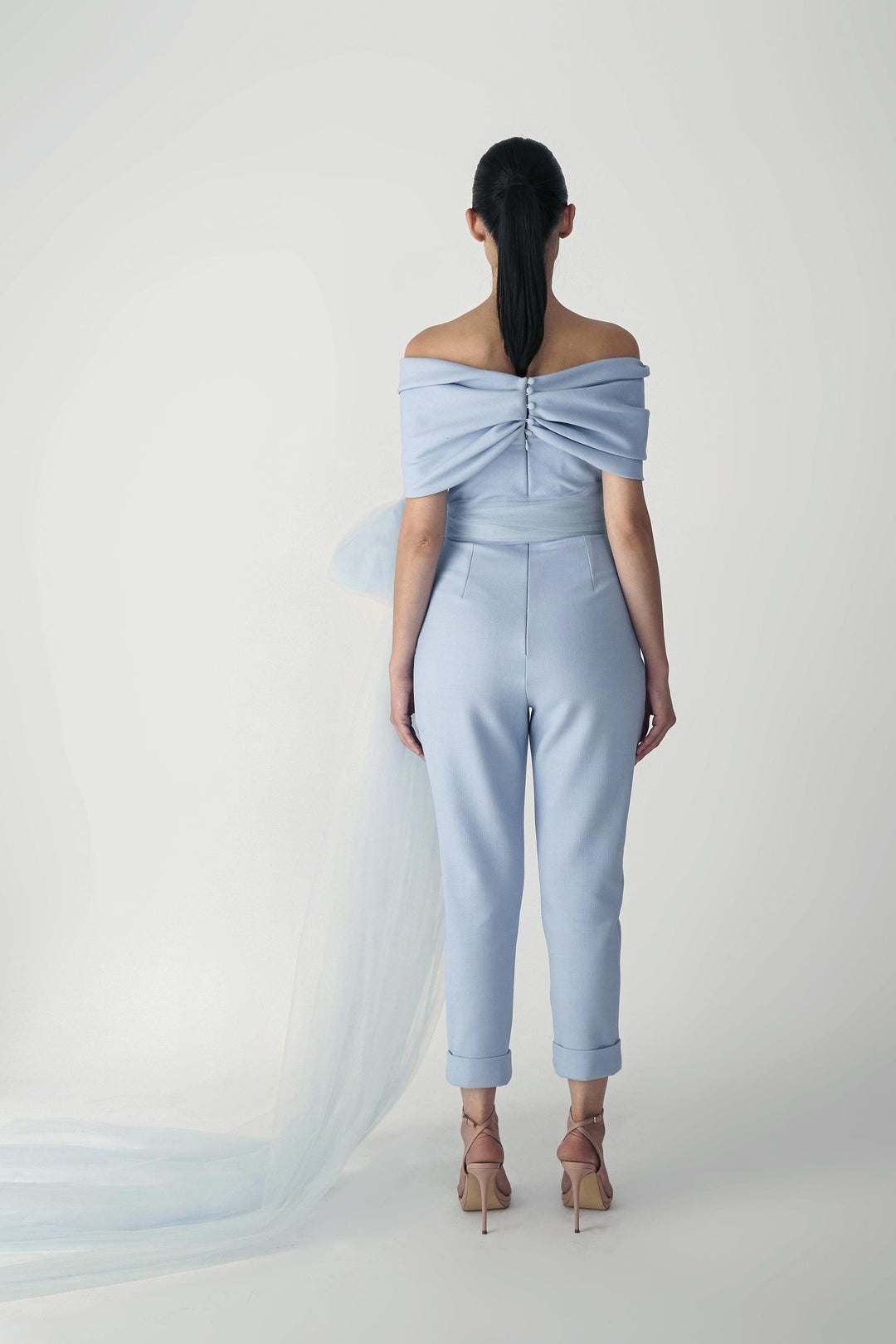 Internally corseted jumpsuit with twisted drape and tapered pants